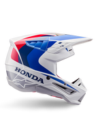 Alpinestars Honda S-M5-hjälm ECE, motocrosshjälm, vit, blå och röd, sidoprofil, aerodynamisk design med integrerat visir, flera ventilationsöppningar, glansig finish, tydlig Honda-logotyp och Alpinestars-logotyp