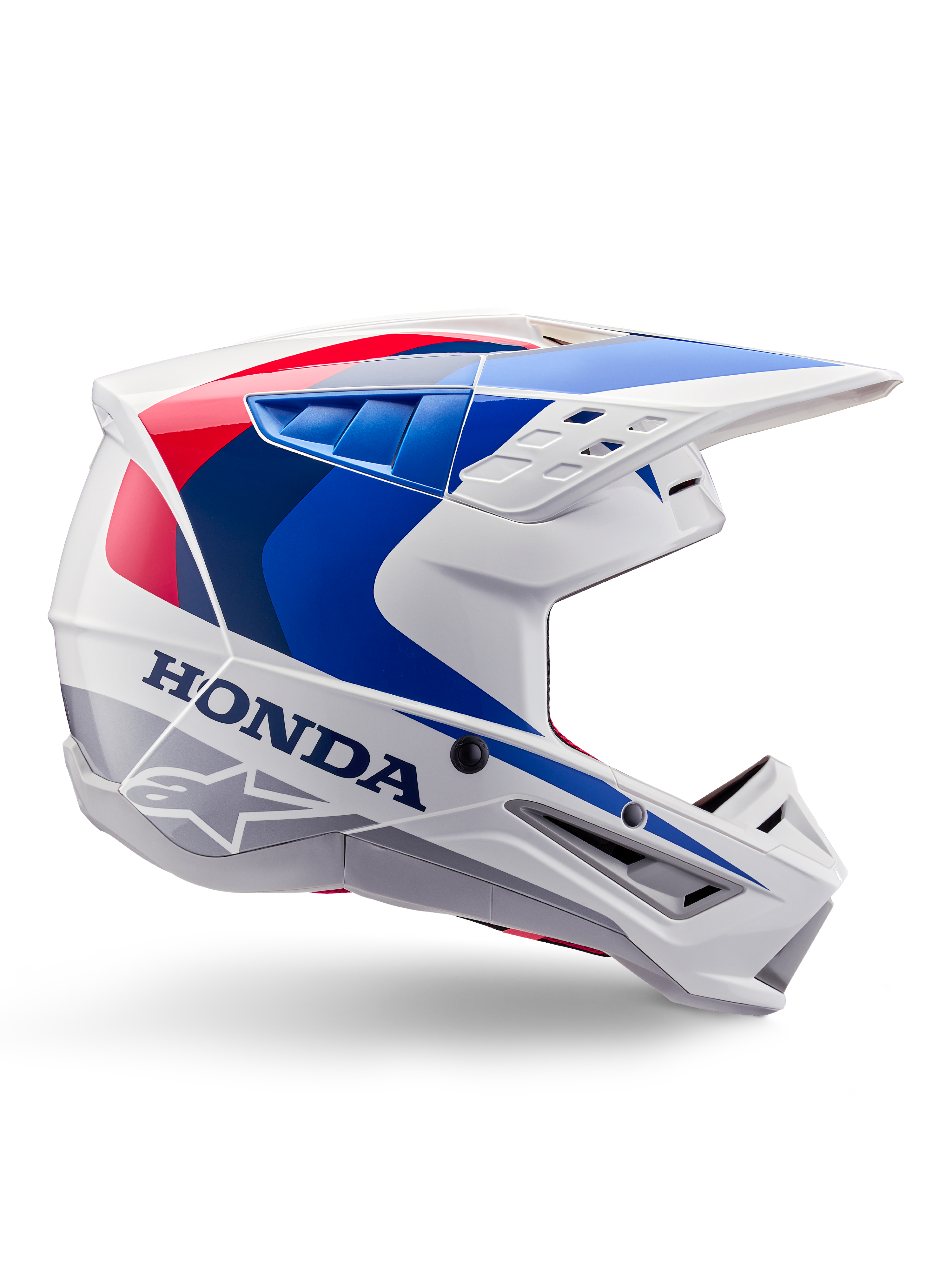 Alpinestars Honda S-M5-hjälm ECE, motocrosshjälm, vit, blå och röd, sidoprofil, aerodynamisk design med integrerat visir, flera ventilationsöppningar, glansig finish, tydlig Honda-logotyp och Alpinestars-logotyp