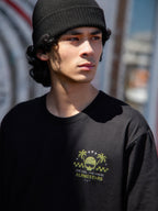 Alpinestars Order CSF Tee, kortärmad t-shirt, svart, limegrön logotyp med hjälm och palmträd samt texten "One Goal One Vision", avslappnad motorsportinspirerad streetwear