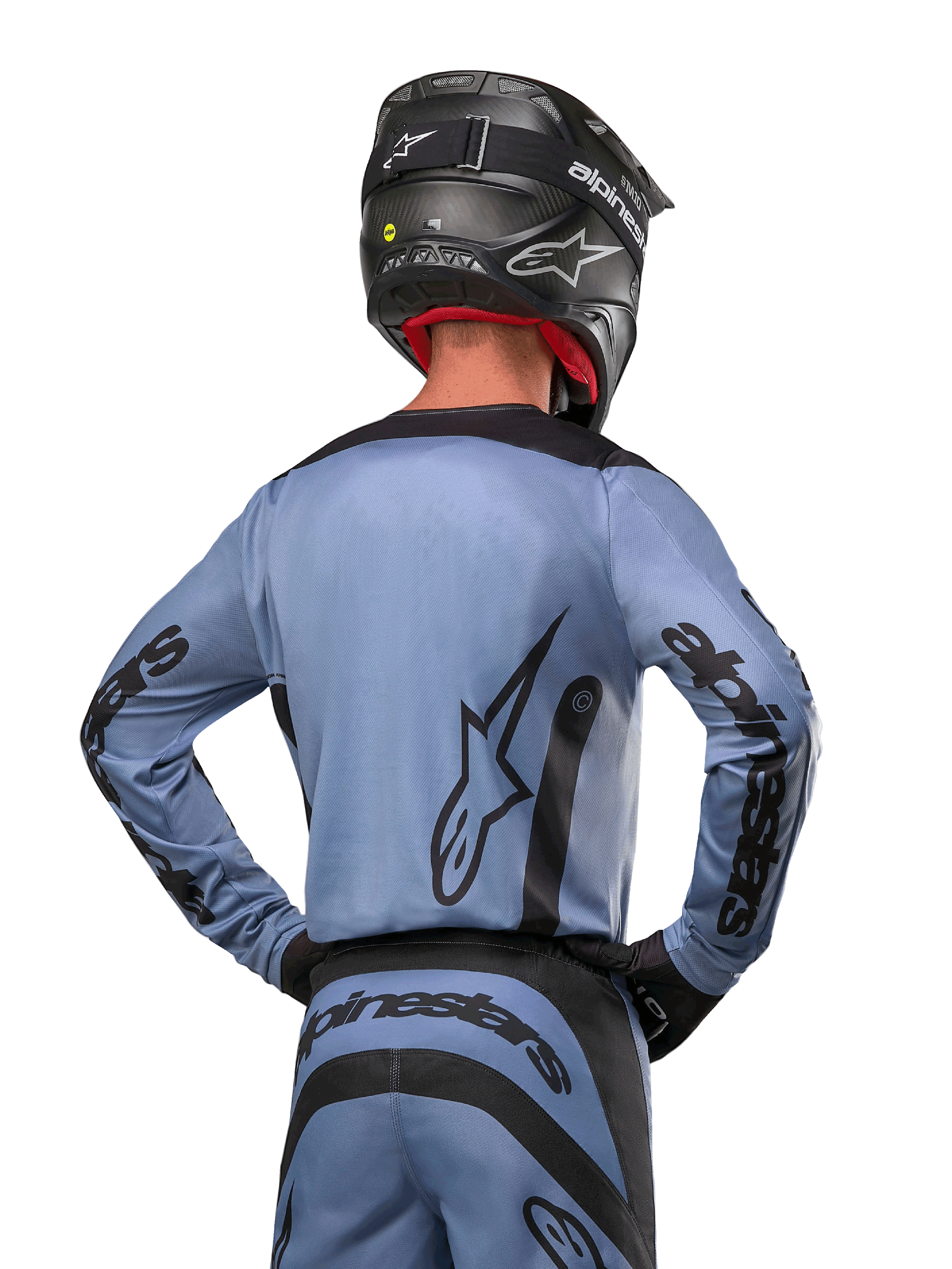 Alpinestars 2024 Fluid Lurv Jersey, Motocross Jersey, Light Blue and Black, back view of rider showing large star logo and sleeve branding, worn with a black helmet and matching off-road pants, professional racing apparel