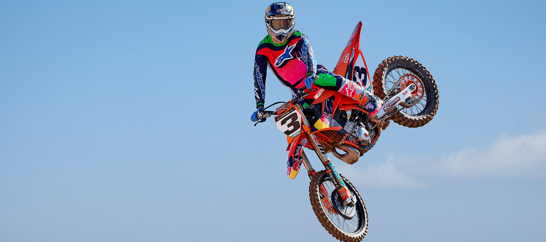 Alpinestars Supertech M10 Records Helmet and Tech 10 Records Boots, Multicolor Motocross gear worn by jumping rider.