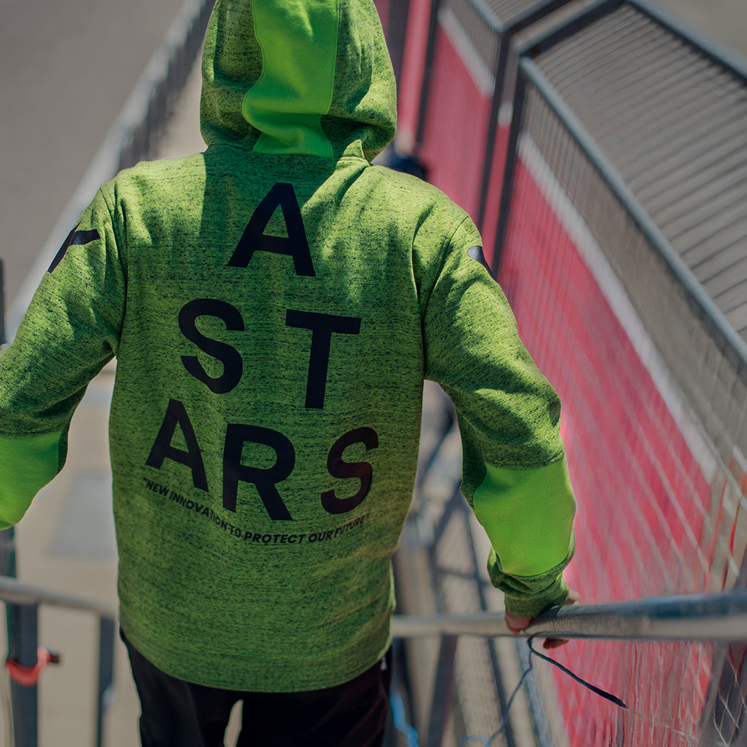 Alpinestars Perpetuate Hoodie, baksida, limegrön melerad fleece, stor svart ASTARS-textgrafik på ryggen, casual sportkläder med tygpaneler och huva med dragsko