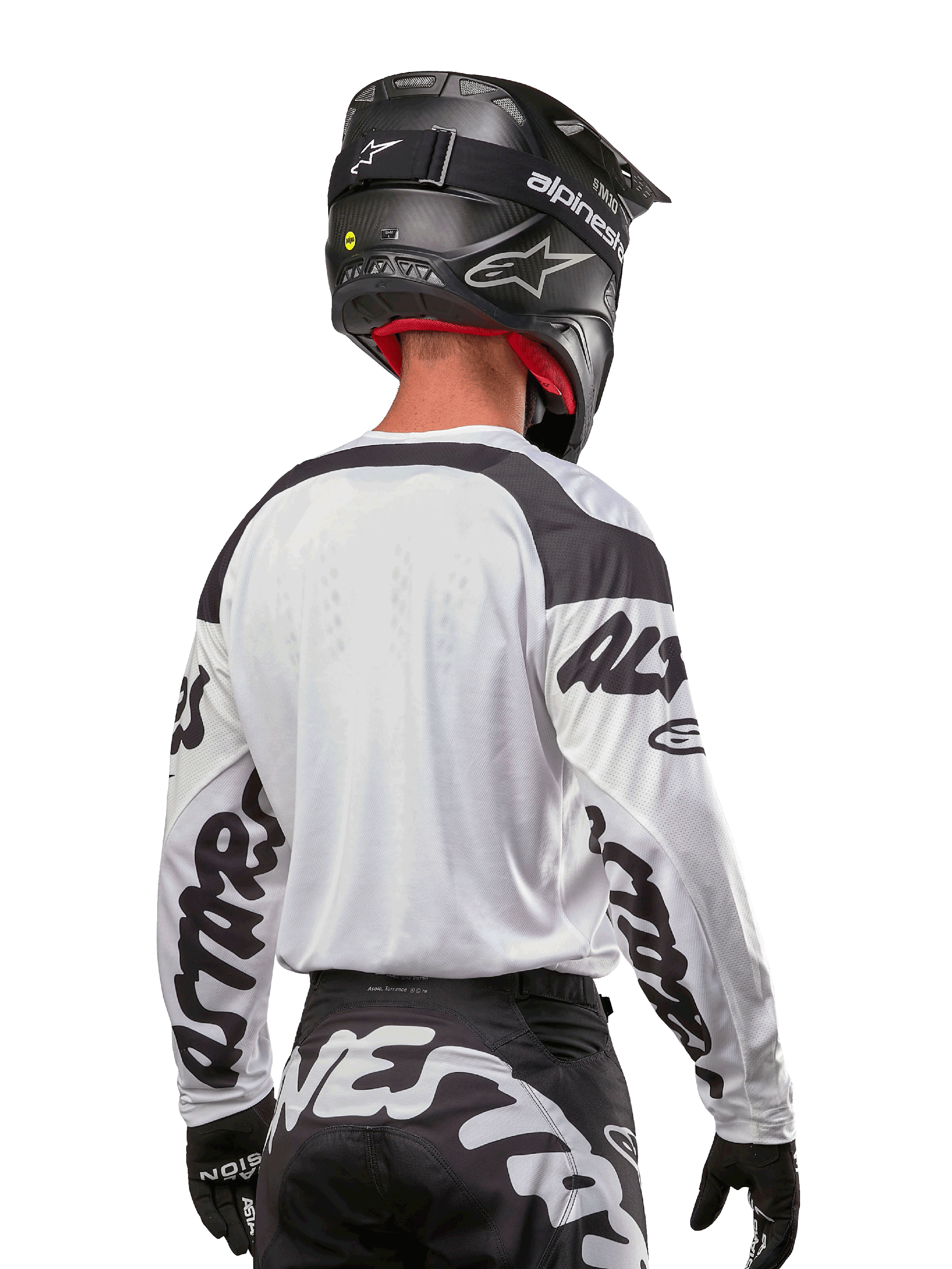Alpinestars 2024 Racer Hana Jersey, White and Black, back view showing ergonomic fit and bold sleeve branding, paired with a black motocross helmet and matching black and white pants, high-performance racing gear for off-road riding