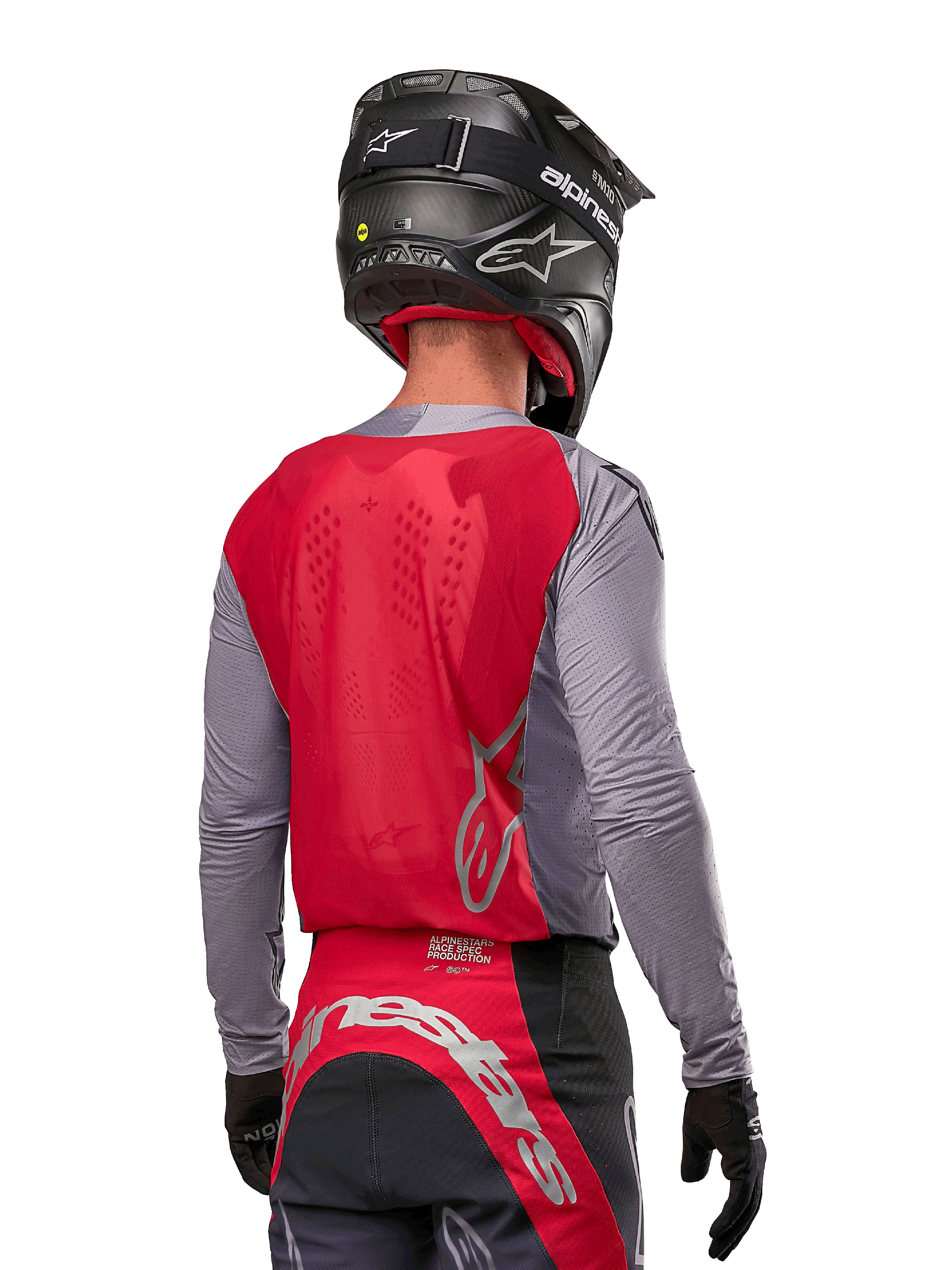 Motocross rider from behind wearing the Alpinestars 2024 Supertech Dade Jersey in Iron Red Berry and grey, featuring a breathable mesh back panel and silver logo accents, paired with a black helmet and matching racing pants for professional off-road performance