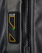 Tech-Air 5 LED status panel on a dark gray textile vest, featuring a glowing green light and large black zipper.