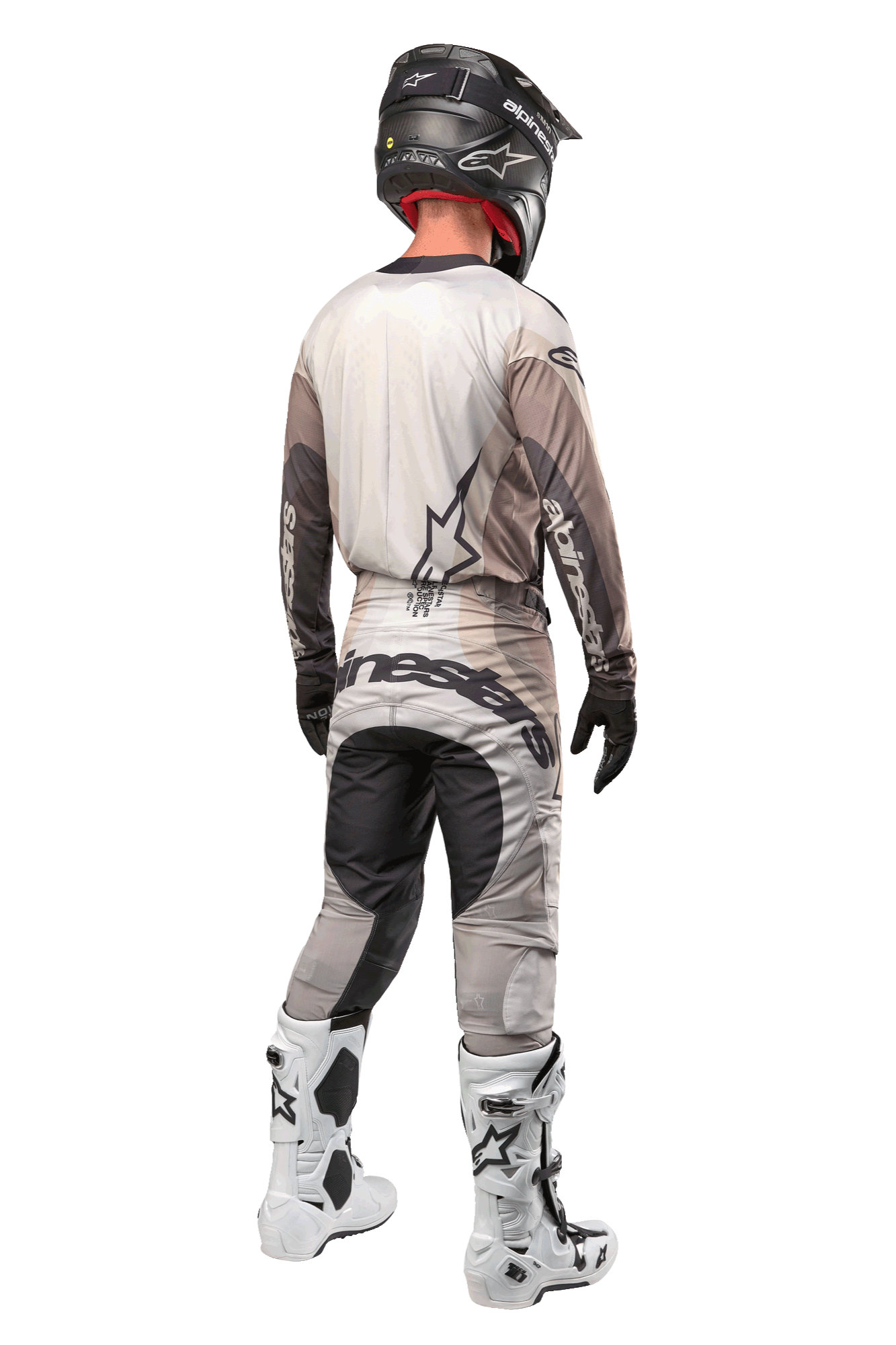 Alpinestars 2024 Techstar Pneuma Pants, Motocross Pants, Dark Sand and Iron Dust Gray, back view worn by a rider with a matching jersey, white and black boots, and a black helmet, featuring bold Alpinestars branding on the seat and reinforced dark panels