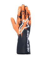 Alpinestars Tech-1 K V3-handskar, kartinghandskar, svarta, orangea och vita, med en sublimerad grafisk design med orangea penseldragsmönster på en svart bas, stor vit Astar-logotyp på ovansidan, vertikal Alpinestars-text på kragen, professionell kartingutrustning